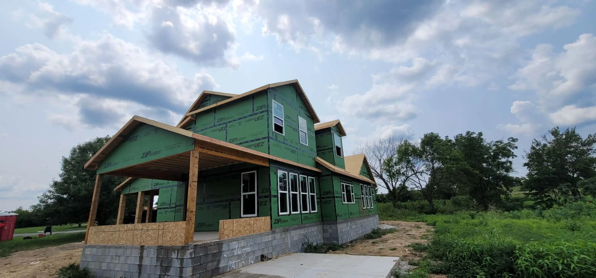 Two-story farmhouse framed with wraparound covered porch